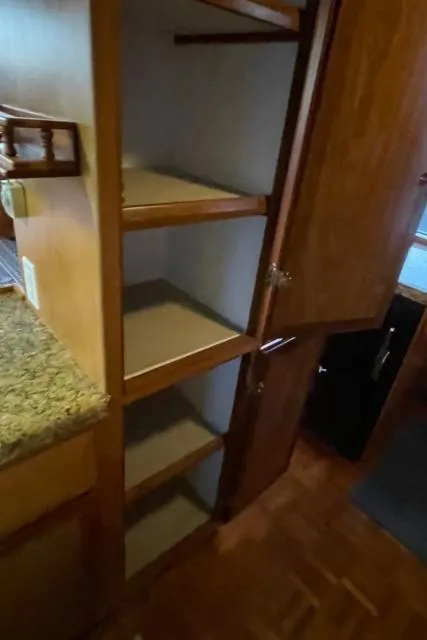 Slide: The Image of 1994 DeFever Double Cabin interior with open wooden storage shelves. - 20