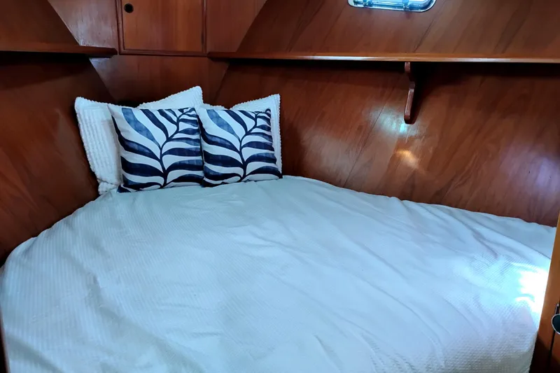 Slide: The Image of Cozy cabin bed in 1994 DeFever Double Cabin yacht with decorative pillows. - 21