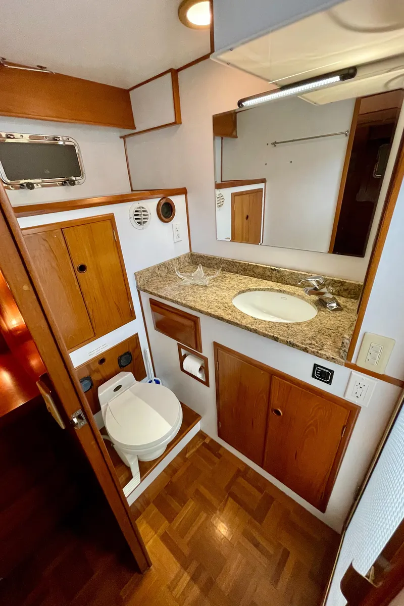 Slide: The Image of 1994 DeFever Double Cabin bathroom with wood accents, granite countertop, and compact design. - 23