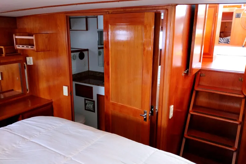 Slide: The Image of 1994 DeFever Double Cabin interior with wooden finish, showing bedroom and stairs. - 27