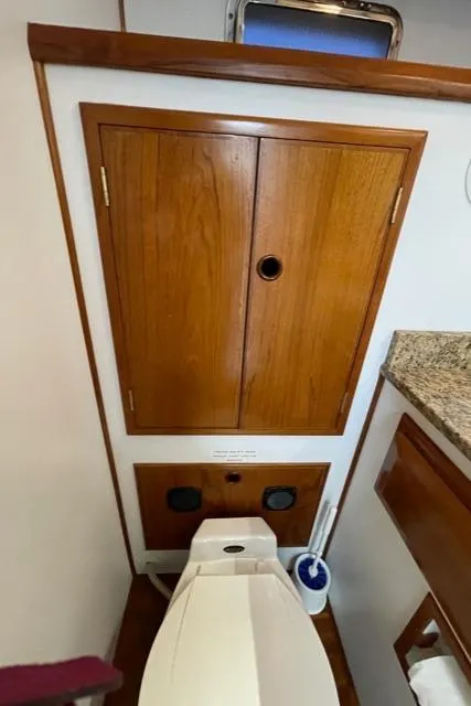 Slide: The Image of 1994 DeFever Double Cabin bathroom with wooden cabinets and modern toilet. - 29