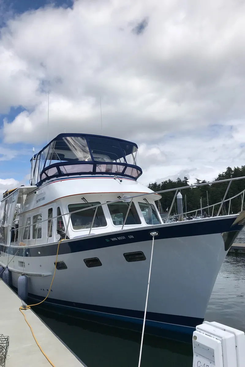 Slide: The Image of 1994 DeFever Double Cabin yacht docked under cloudy sky. - 3