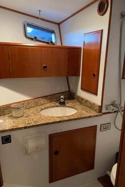 Slide: The Image of 1994 DeFever Double Cabin bathroom with granite countertop and wooden cabinets. - 30