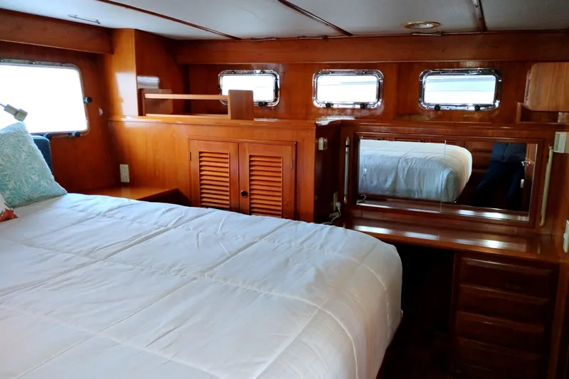 Slide: The Image of 1994 DeFever Double Cabin interior with wooden furnishings and a cozy bed. - 34