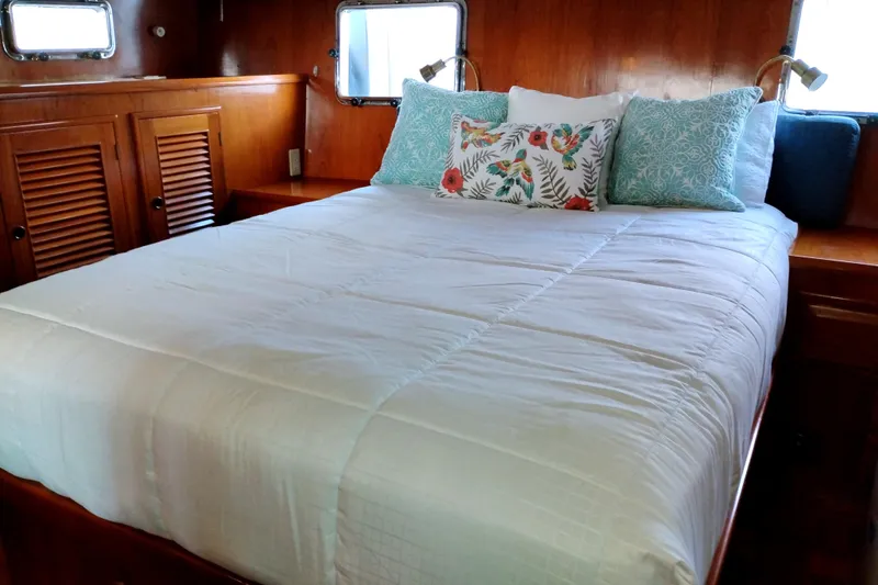 Slide: The Image of Cozy bedroom in 1994 DeFever Double Cabin yacht with elegant wood paneling. - 35