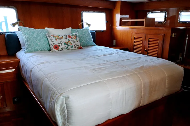 Slide: The Image of Cozy bedroom in 1994 DeFever Double Cabin yacht with plush bedding and wooden interior. - 36