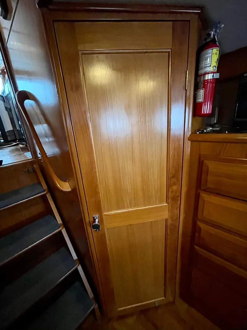 Slide: The Image of Wooden interior door on 1994 DeFever Double Cabin yacht, with stairs and fire extinguisher nearby. - 39