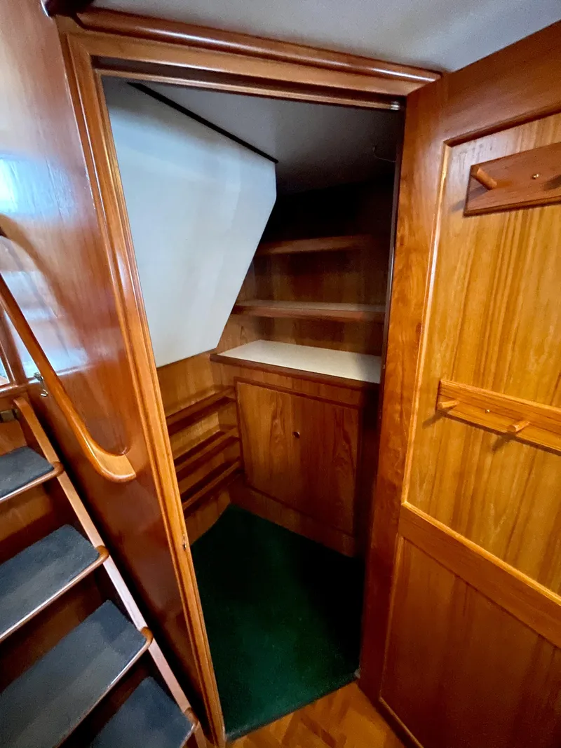 Slide: The Image of 1994 DeFever Double Cabin interior with wooden cabinetry and green carpet. - 40