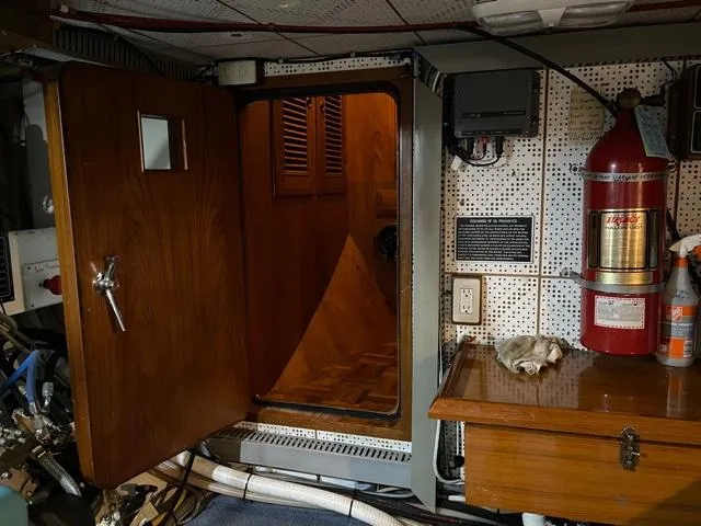 Slide: The Image of 1994 DeFever Double Cabin interior with open wooden door, fire extinguisher, and control panel. - 49