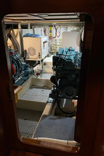Slide: The Image of Engine room of 1994 DeFever Double Cabin yacht, showcasing machinery and equipment. - 51