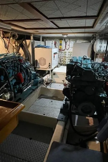 Slide: The Image of Engine room of 1994 DeFever Double Cabin yacht with dual engines and equipment. - 52