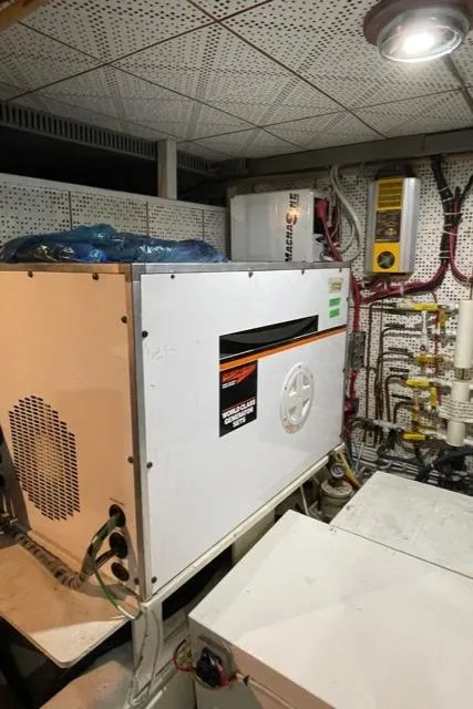 Slide: The Image of Engine room of 1994 DeFever Double Cabin yacht with machinery and control panels. - 53