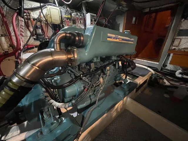 Slide: The Image of Engine room of a 1994 DeFever Double Cabin yacht, showcasing detailed machinery and components. - 56