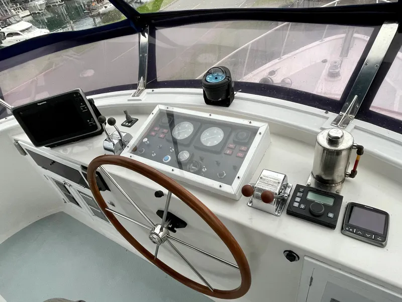 Slide: The Image of 1994 DeFever Double Cabin helm with steering wheel, navigation instruments, and control panel. - 9