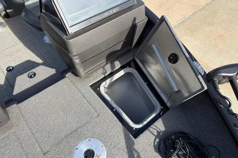 Slide: The Image of 2022 Tracker Pro Guide V-175 Combo boat with open storage compartment. - 13