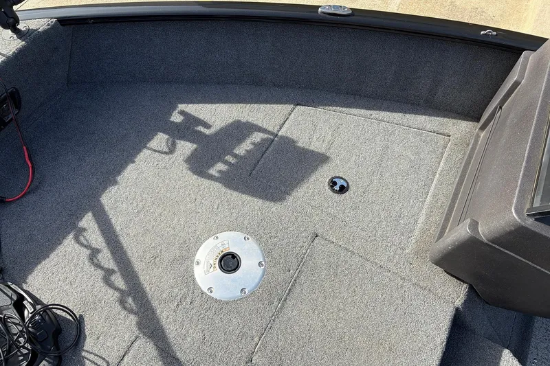 Slide: The Image of 2022 Tracker Pro Guide V-175 Combo boat interior with carpeted deck and storage compartments. - 15