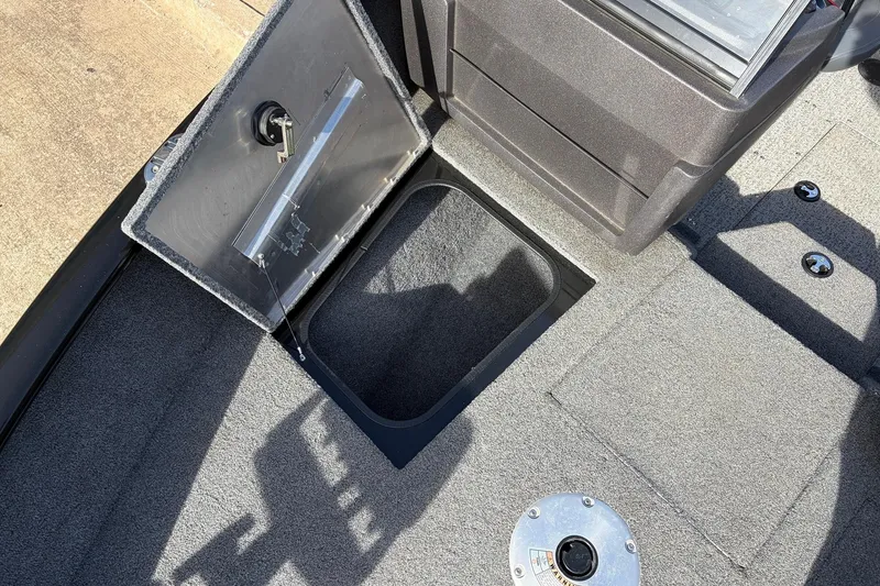 Slide: The Image of 2022 Tracker Pro Guide V-175 Combo boat interior with open storage compartment. - 17