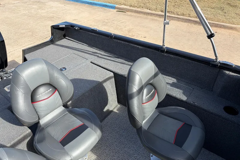Slide: The Image of 2022 Tracker Pro Guide V-175 Combo boat interior with gray seats and carpeted flooring. - 24