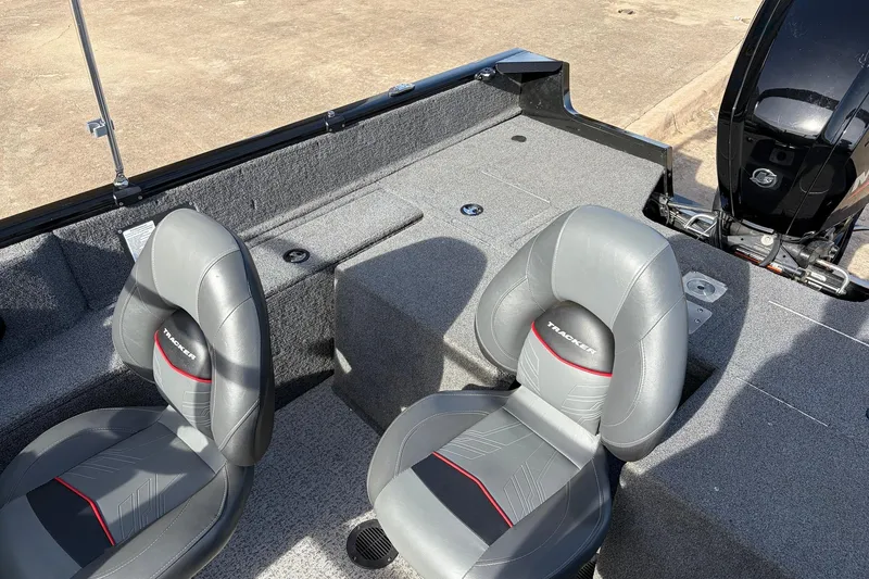 Slide: The Image of 2022 Tracker Pro Guide V-175 Combo boat interior with gray seats and motor. - 25