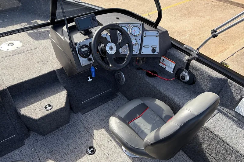 Slide: The Image of 2022 Tracker Pro Guide V-175 Combo boat interior with steering wheel and dashboard controls. - 26