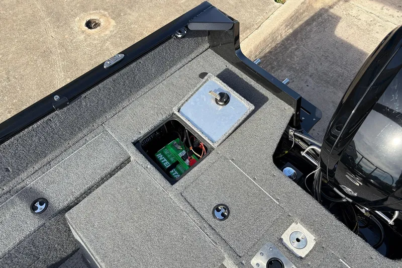 Slide: The Image of 2022 Tracker Pro Guide V-175 Combo boat interior with battery compartment open. - 40