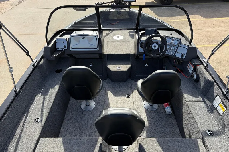 Slide: The Image of 2022 Tracker Pro Guide V-175 Combo boat interior with dual seats and control panel. - 9