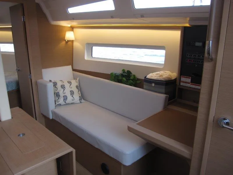 Slide: The Image of Interior of 2024 Jeanneau 380 sailboat with modern seating and natural light. - 12