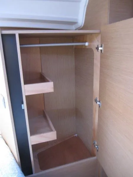 Slide: The Image of 2024 Jeanneau 380 yacht interior closet with shelves and hanging rod. - 26