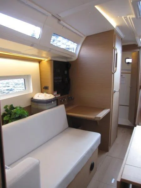 Slide: The Image of Interior of 2024 Jeanneau 380 sailboat with modern seating and wooden finishes. - 29