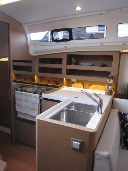 Slide: The Image of Modern kitchen area in 2024 Jeanneau 380 sailboat with sink and stove. - 7