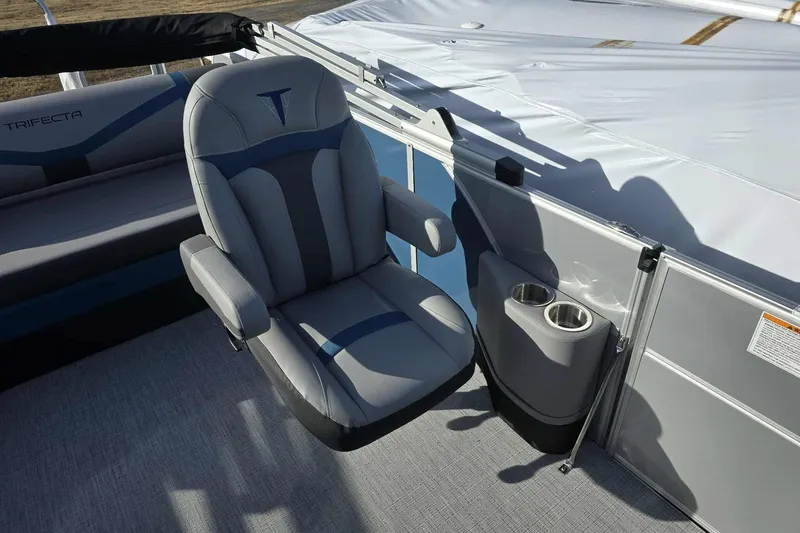 Slide: The Image of Luxurious seating on 2026 Trifecta 24ULCS3 pontoon boat with cup holders and sleek design. - 11