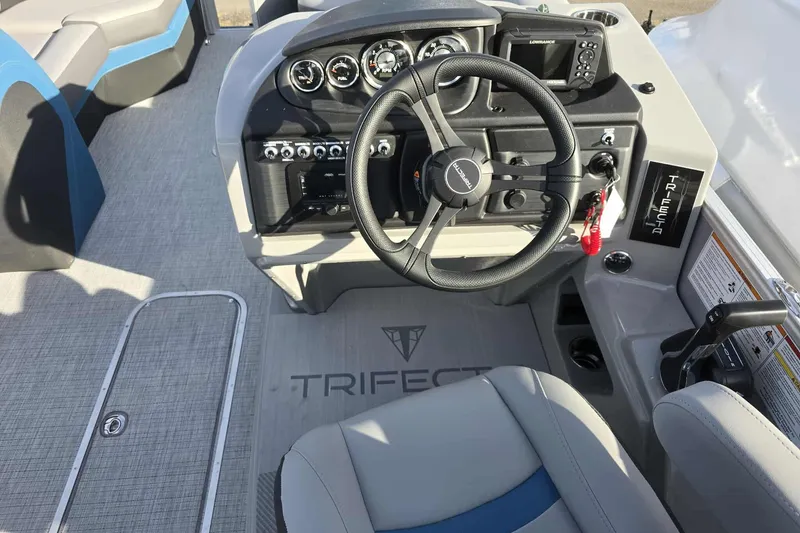 Slide: The Image of Steering console of 2026 Trifecta 24ULCS3 boat with modern controls and dashboard. - 14