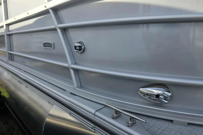 Slide: The Image of 2026 Trifecta 24ULCS3 pontoon boat exterior with sleek silver finish and chrome details. - 4