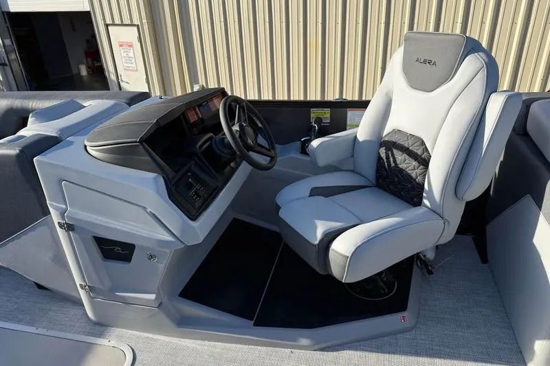 Slide: The Image of Captain's seat of 2026 Alera M 25Q boat with modern dashboard. - 11