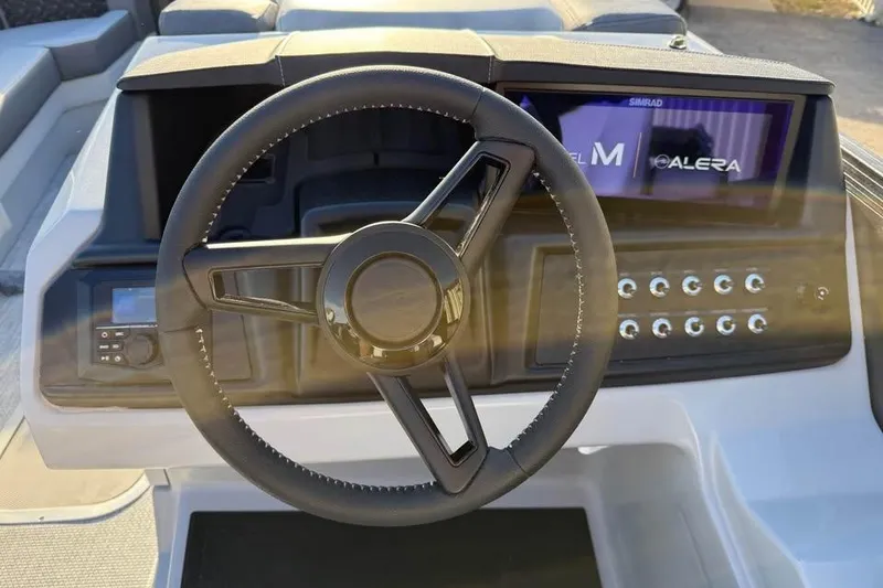 Slide: The Image of Steering wheel and dashboard of 2026 Alera M 25Q boat with control panel. - 12