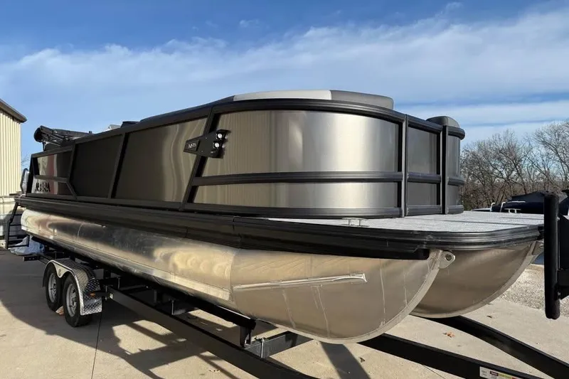Slide: The Image of 2026 Alera M 25Q pontoon boat on trailer, parked outdoors under blue sky. - 3