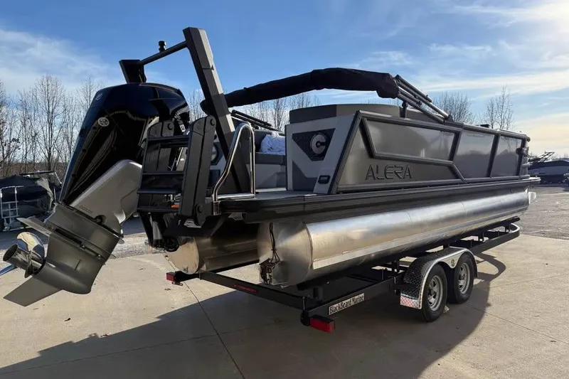 Slide: The Image of 2026 Alera M 25Q pontoon boat on trailer, featuring a powerful outboard motor. - 5