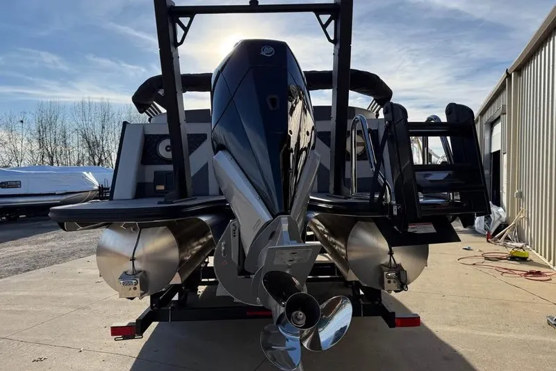 Slide: The Image of Alera M 25Q 2026 pontoon boat with powerful outboard motor, docked outdoors. - 6