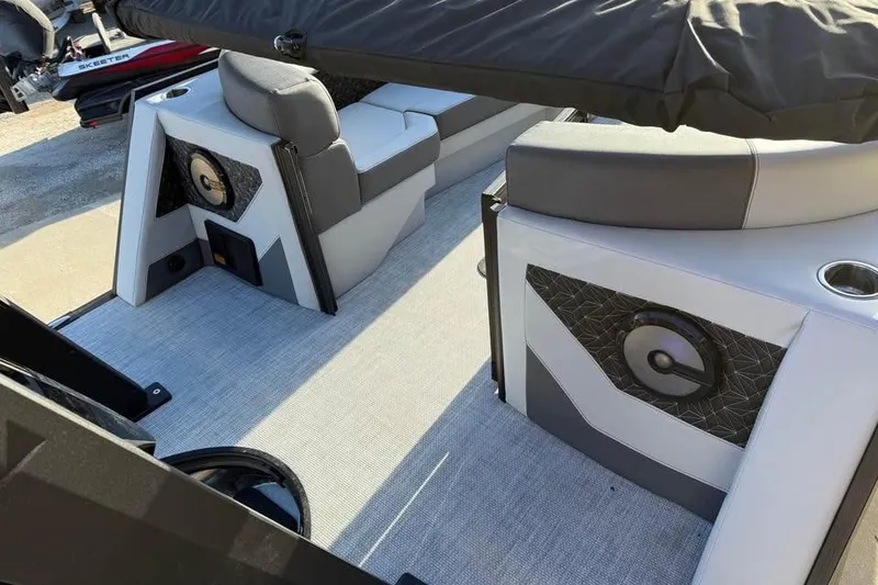 Slide: The Image of Interior of 2026 Alera M 25Q boat with modern seating and speaker system. - 9