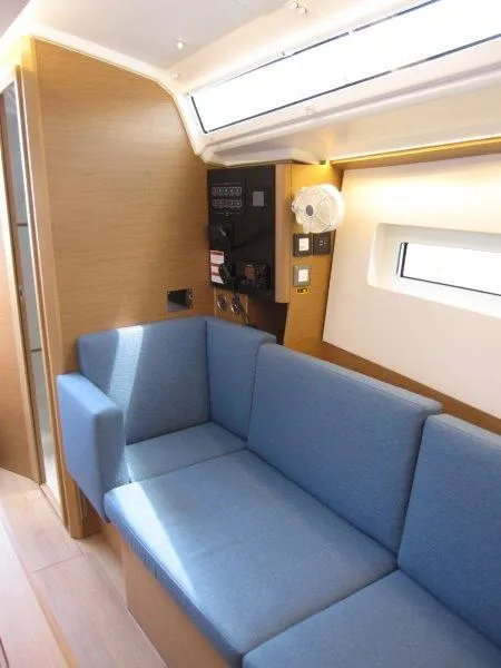 Slide: The Image of 2025 Jeanneau Sun Odyssey 350 interior with blue sofa and modern design. - 2