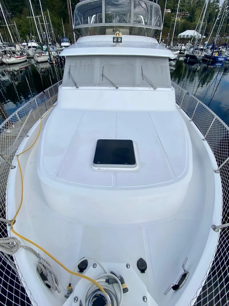Slide: The Image of 1999 Ocean Alexander 510 Pilothouse yacht docked in marina. - 14
