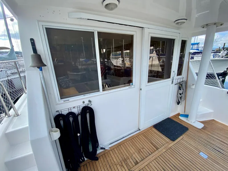 Slide: The Image of 1999 Ocean Alexander 510 Pilothouse, aft deck with wood flooring and sliding doors. - 16