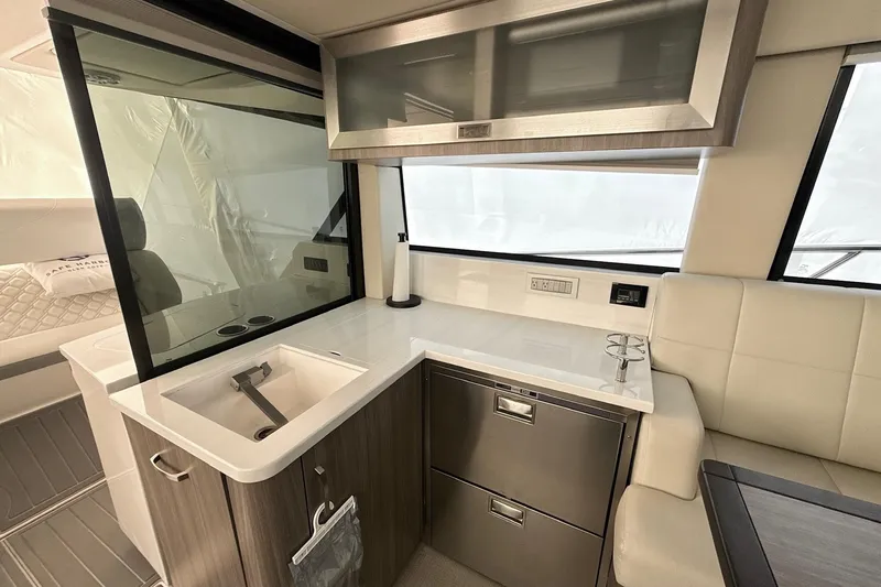 Slide: The Image of Modern kitchen area in 2022 Regal 38 XO yacht with sleek cabinetry and appliances. - 12