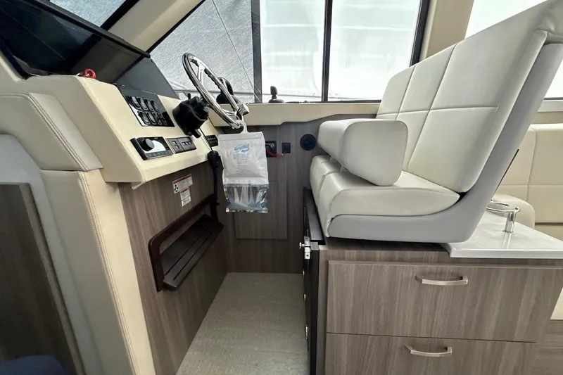 Slide: The Image of Helm station of 2022 Regal 38 XO boat with modern controls and seating. - 18