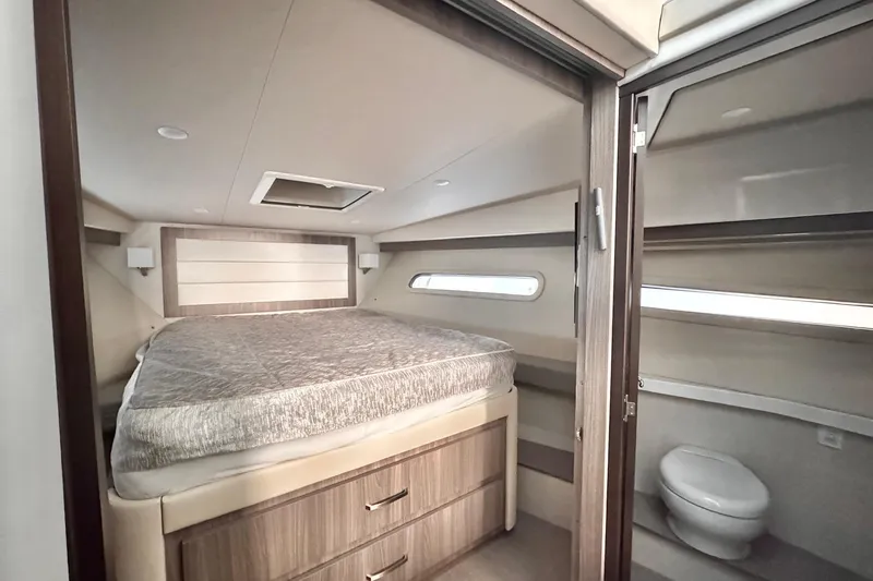 Slide: The Image of Luxurious 2022 Regal 38 XO yacht interior with cozy bed and modern bathroom. - 21