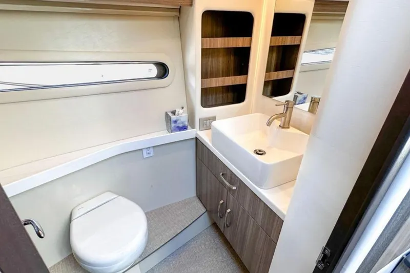 Slide: The Image of Luxurious bathroom in 2022 Regal 38 XO yacht with modern sink and toilet. - 22