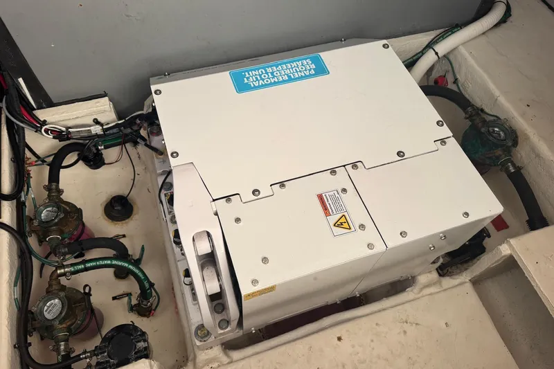 Slide: The Image of Engine compartment of 2022 Regal 38 XO boat, featuring mechanical components and wiring. - 28