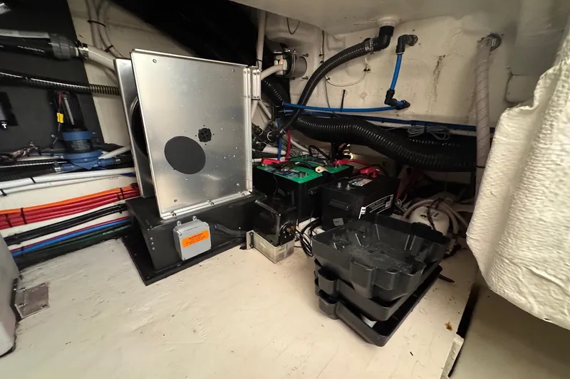 Slide: The Image of Engine room of 2022 Regal 38 XO boat with wiring and battery components. - 31