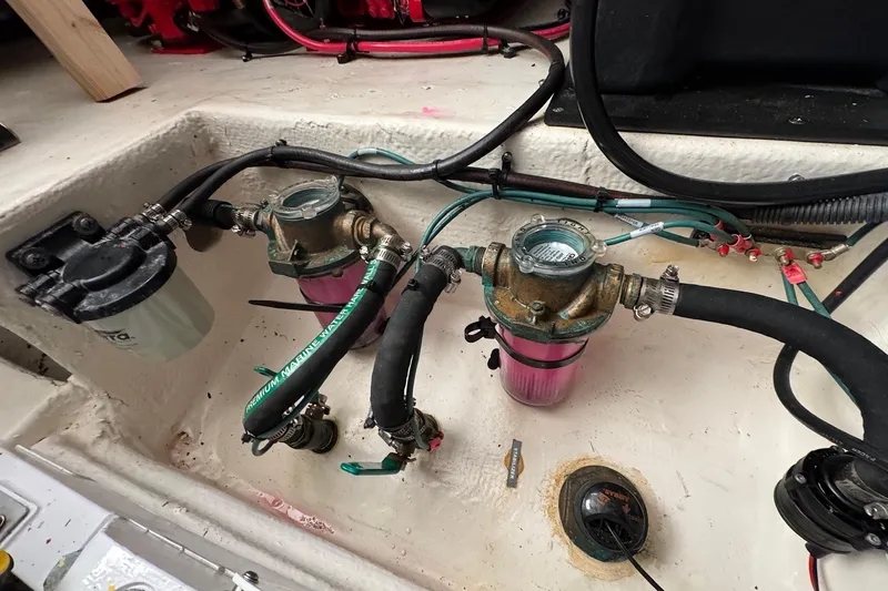 Slide: The Image of Engine compartment of a 2022 Regal 38 XO boat showing fuel filters and hoses. - 32