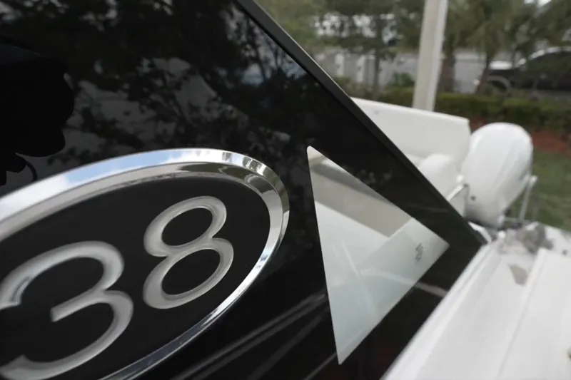 Slide: The Image of Close-up of 2022 Regal 38 XO boat emblem and sleek design details. - 4